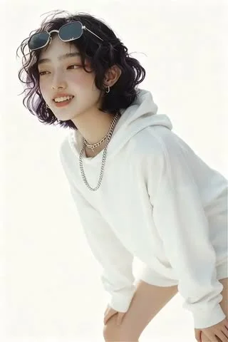 A person with short wavy dark-purple hair wearing a white hoodie and layered silver chain necklaces, with sunglasses resting on top of their head, posed against a bright overexposed white background with high-key lighting